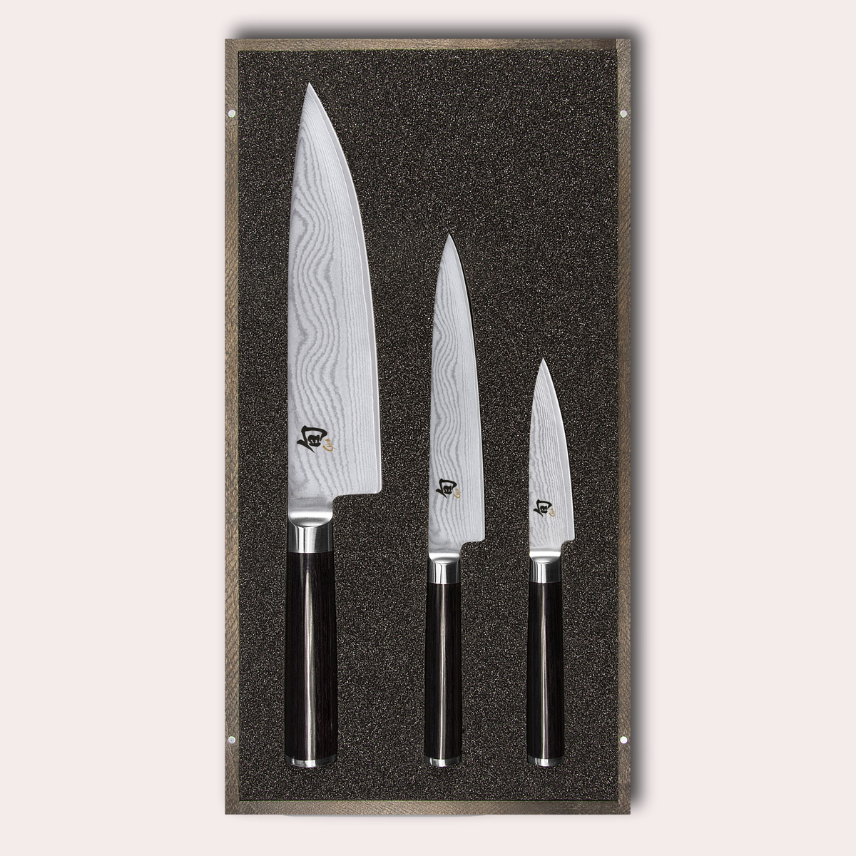 KAI Shun 3 piece set, chef, utility and paring knives. Damascus blade with razor sharp edge and black pakkawood handle.