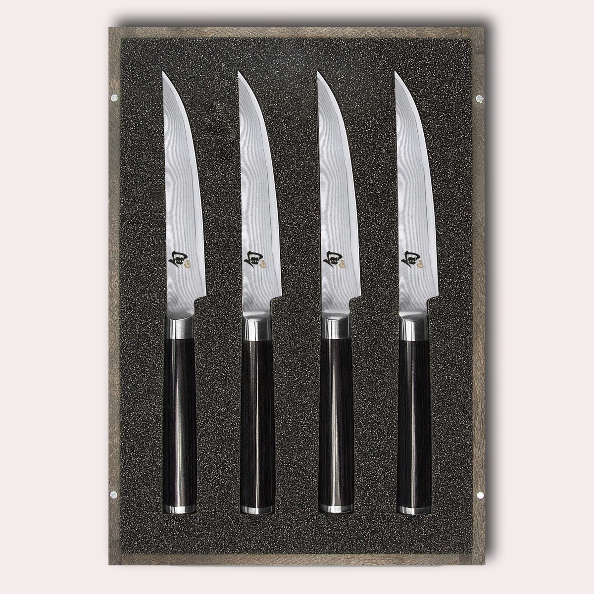 KAI Shun 4 piece steak knife set. Damascus blade with razor sharp edge and black pakkawood handle.