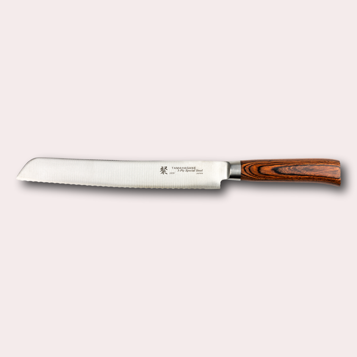 Tamahagane San Bread knife, with 3 ply special steel blade, and brown micarta handle. Sold by japanese-knives.co.uk