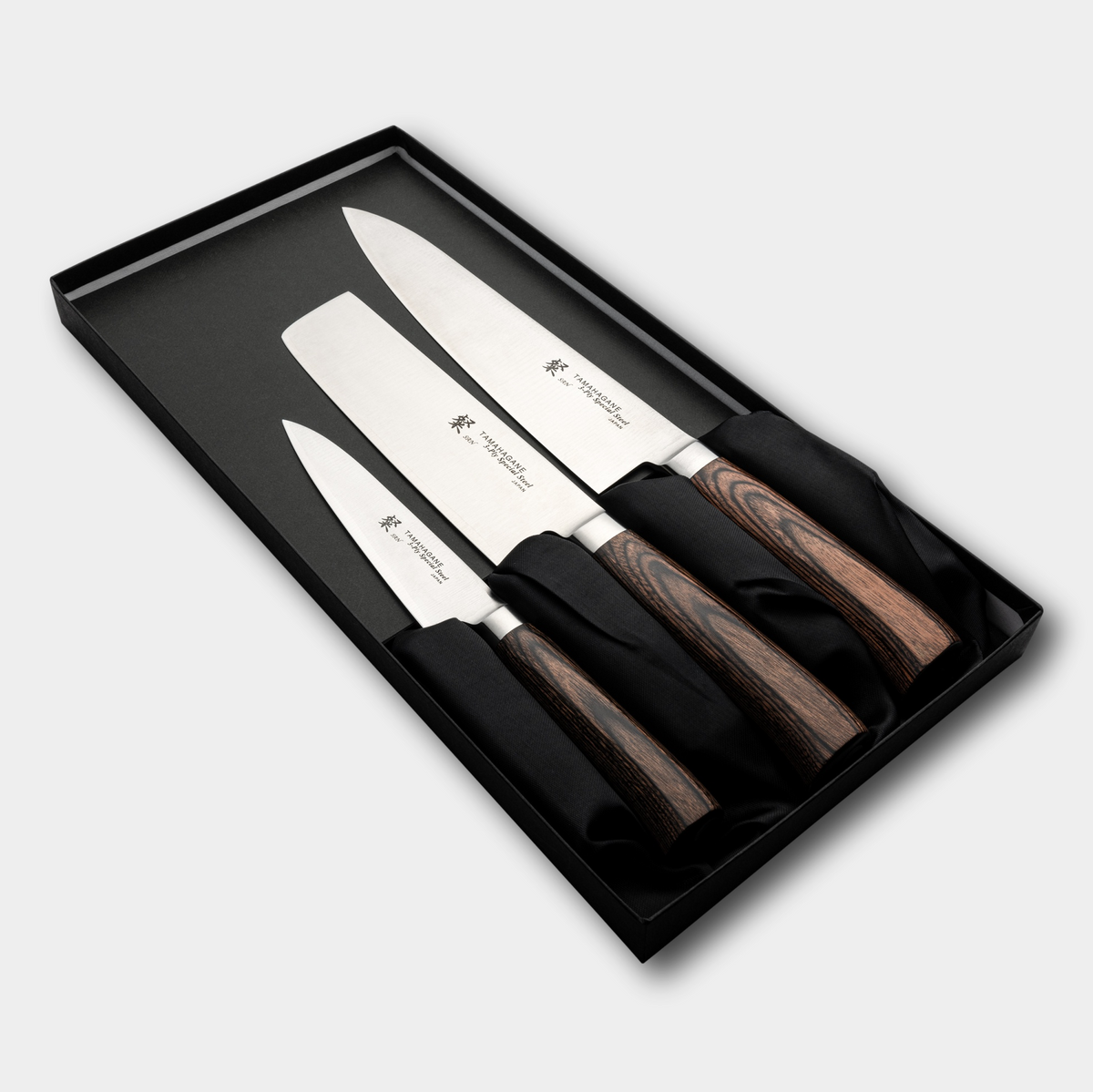 Tamahagane San 3 piece knife set, with 3 ply special steel blades, and brown micarta handles. Sold by japanese-knives.co.uk