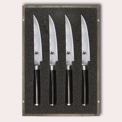 KAI Shun 4 piece steak knife set. Damascus blade with razor sharp edge and black pakkawood handle. 