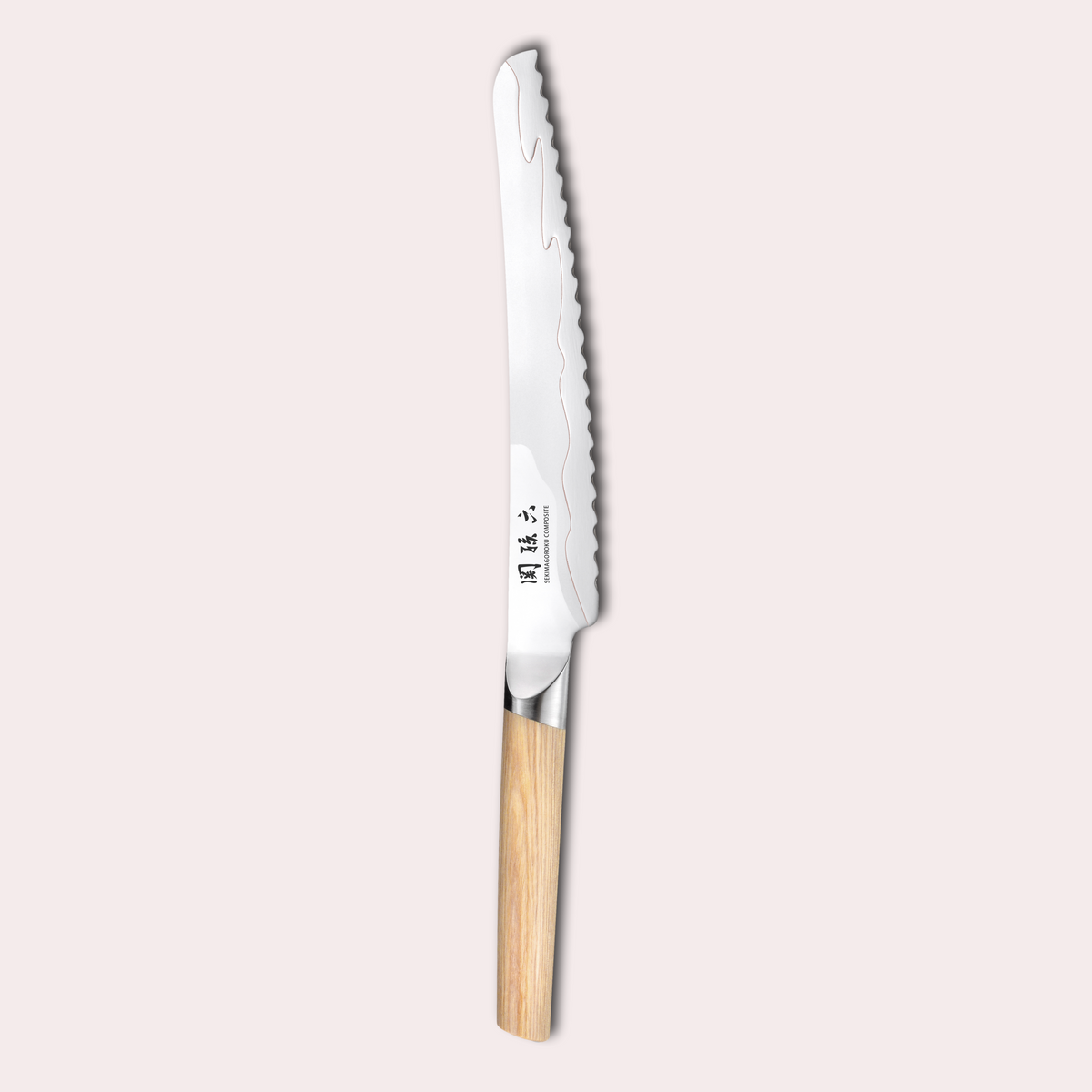 Kai Seki Magoroku Composite bread knife. Natural wood handle with the two grades of blade metal separated by a beautiful copper flash.
