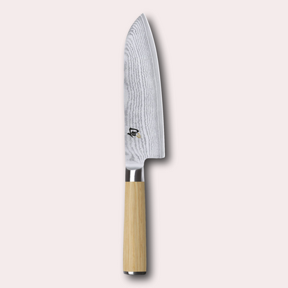 Kai Shun White 18cm Santoku knife.  Light ash coloured pakkawood handle, meets a VG Max steel core blade wrapped in 32 layers of Damascus Steel.