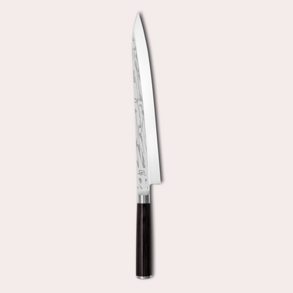 Kai Shun Pro Sho slicing knife. VG10 steel honed on one side only. Decorative blade design and black pakkawood handle. japanese-knives.co.uk