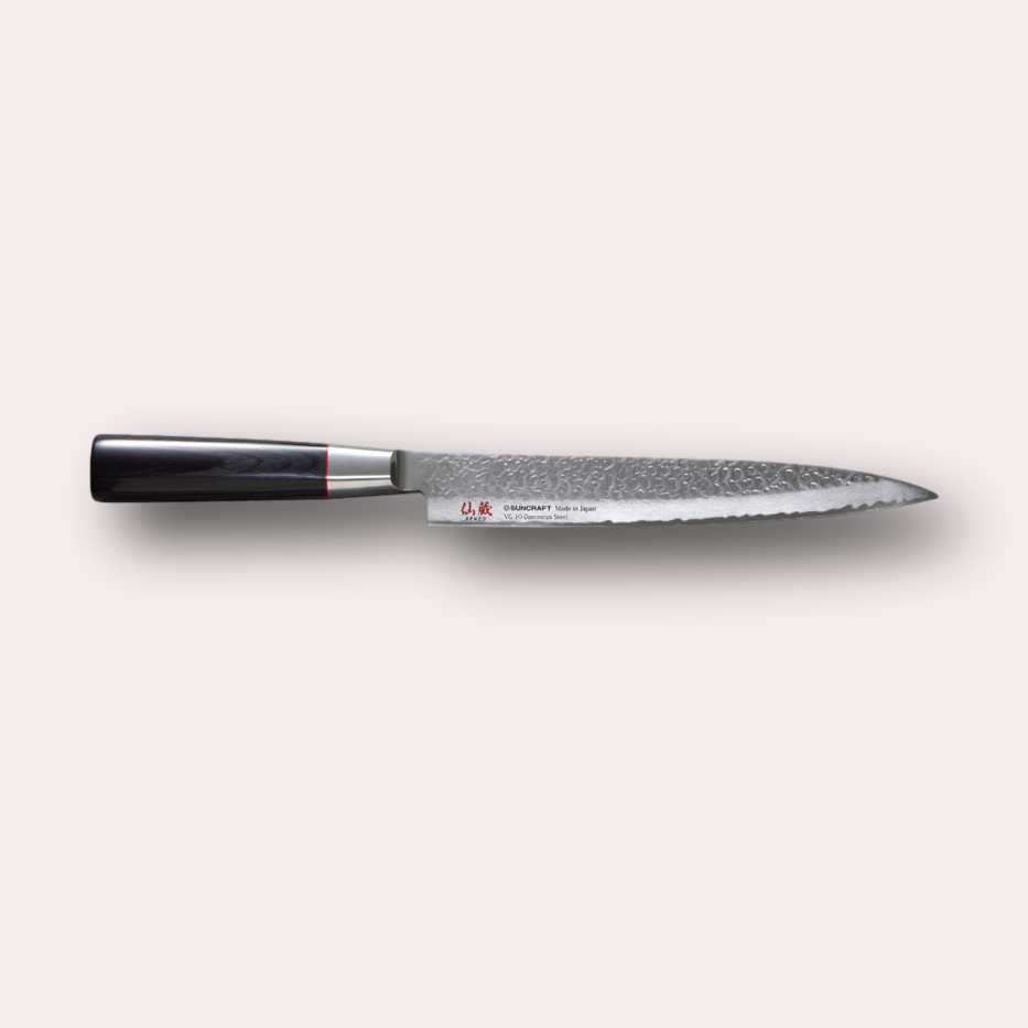 Suncraft Senzo Sujihiki Carving knife with VG10 hammered finish blade, and black pakkawood handle.